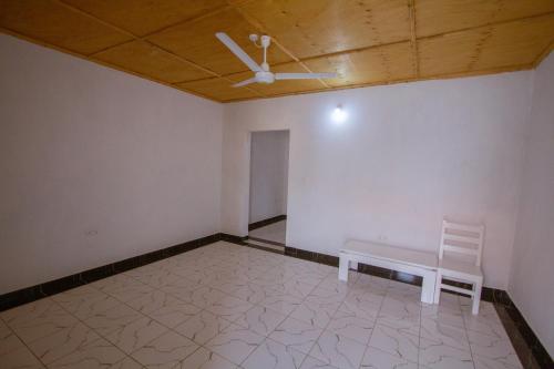 a empty room with a bench and a ceiling at Havillah Gardens Watamu in Watamu
