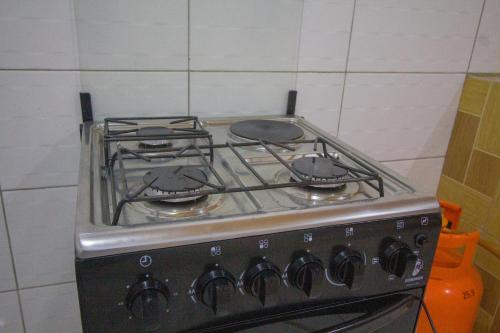 a stove with three burners on it in a kitchen at Havillah Gardens Watamu in Watamu