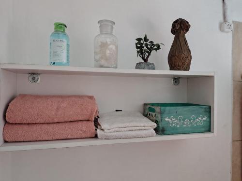 a shelf with towels and other items on it at Casa lupe in Yerba Buena