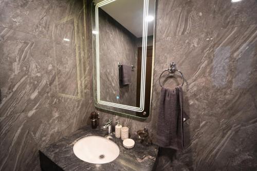 a bathroom with a sink and a mirror at Luxury 1BR Designer Condo at Zeta Mall Islamabad Balcony, Parking & Steps from Giga Mall in Islamabad