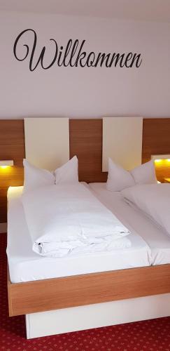 two beds with white sheets and a sign that says wilderness at Central Hotel-Apart München in Munich