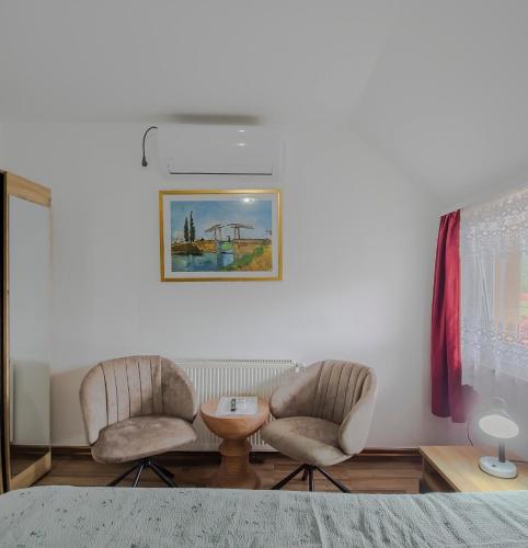 two chairs and a table in a room at House Šapina in Korenica