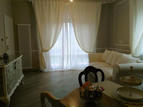 a living room with a couch and a table at La Valinfiore Charming Home in Montecarlo