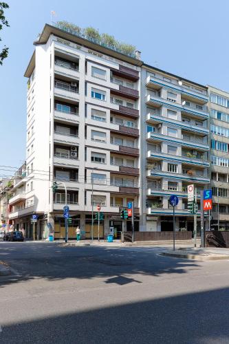 a large white building on the corner of a street at MilanLife Apartments - DTown Charme in Milan