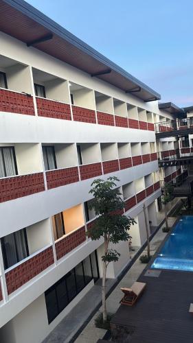 an external view of a building with a swimming pool at Alzeto Coliving in Legian