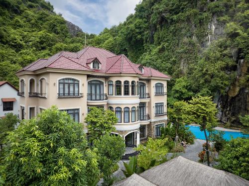 a large white building with a red roof at Indochine Boutique Hotel Ninh Bình in Ninh Binh