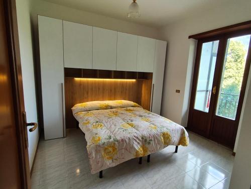 a bedroom with a bed with a wooden headboard at La Serenita' in Marco Simone