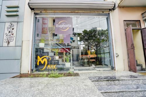 a store window with a sign that says buy and take at Hotel O Euphoria inn in Morādābād