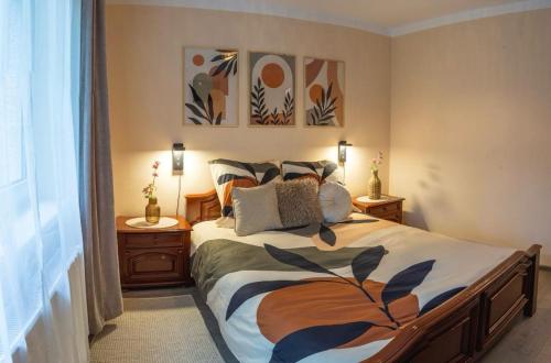 a bedroom with a large bed and two night stands at Stay & Spa Central in Sfântu-Gheorghe