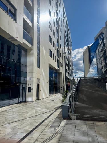 an empty street in a city with tall buildings at ApartmanGrandTrade by Termax in Banja Luka