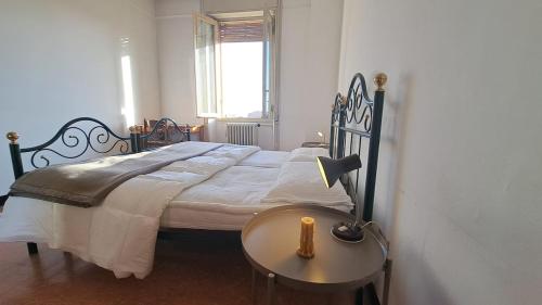 a bedroom with a bed and a table with a lamp at SOLARIA Apartment in Brescia