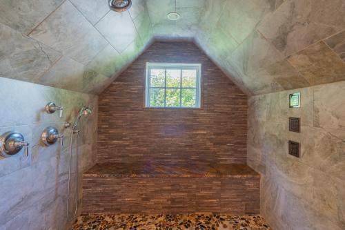 a bathroom with a shower and a window at The Winstead Inn in Harwich