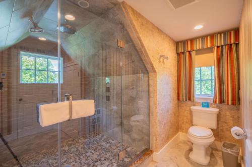 a bathroom with a shower and a toilet at The Winstead Inn in Harwich