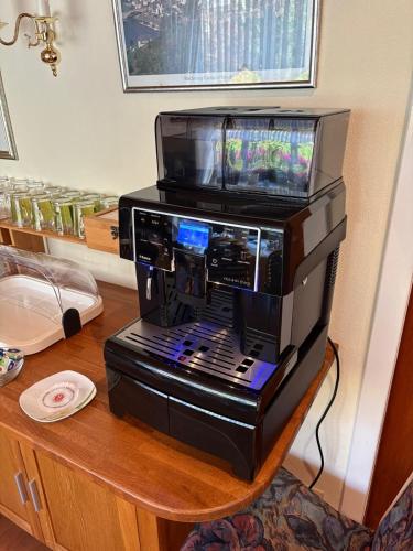 a black printer sitting on a table with a tv at Pension Haus Thies in Cochem