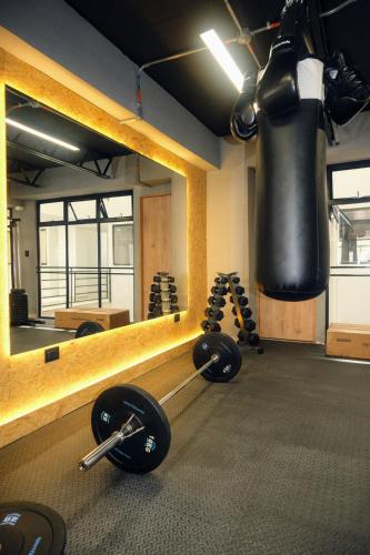 a boxing gym with a mirror and weights at Lienzo Suite in Popayan