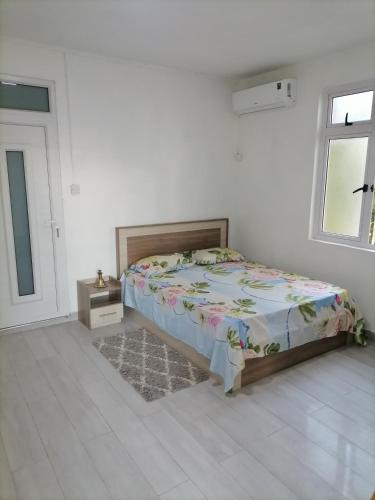 una camera da letto con un letto in una stanza bianca di Villa Orchidee a Trou aux Biches