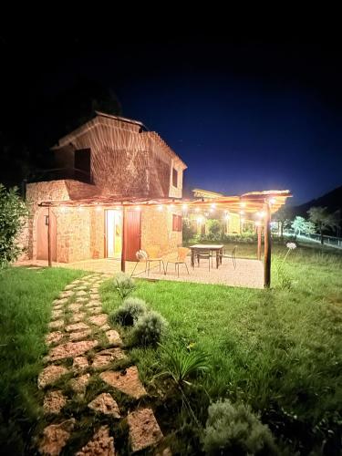 a house with a table and a patio at night at Le Tre Aie in San Giovanni a Piro