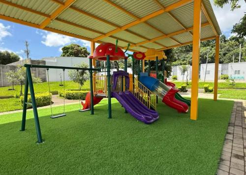 a playground with a slide in a park at Ahuachapan Tiny Rental Homes in Ahuachapán