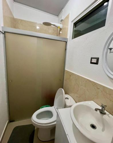 a bathroom with a toilet and a sink at Ahuachapan Tiny Rental Homes in Ahuachapán