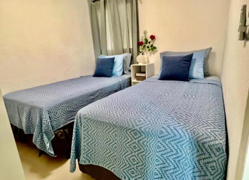 two beds sitting next to each other in a room at Ahuachapan Tiny Rental Homes in Ahuachapán
