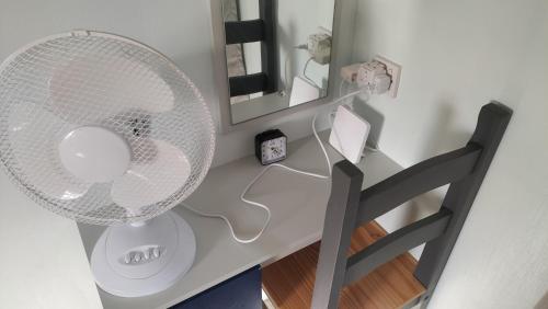 a white desk with a fan and a mirror at Willows 105 Caravan - 7 Lakes in Crowle