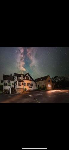 a group of houses on a street at night at The Swan in Munslow