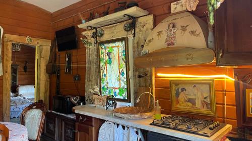 a kitchen with a stove and a sink in a room at Chalet de Bella in Terlo