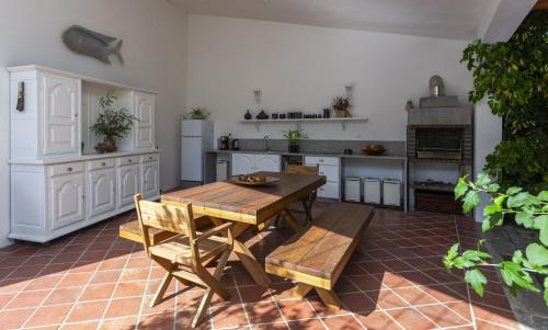 a kitchen with a wooden table and chairs at Casa da Câmara in Tondela