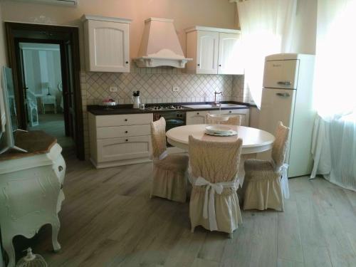 a kitchen with a table and chairs in it at La Valinfiore Charming Home in Montecarlo
