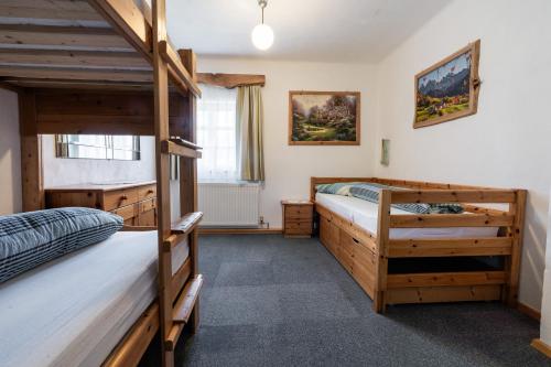 a bedroom with two bunk beds and a window at Ferienwohnung am Abbrandtnergut 
