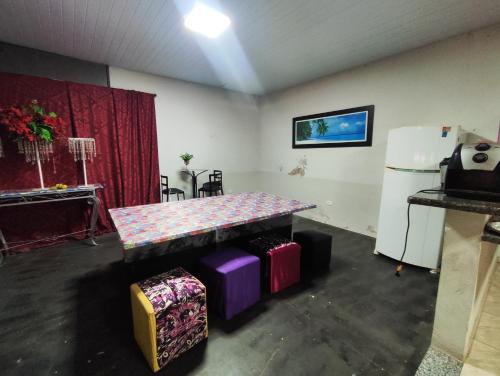 a room with a table and a refrigerator at Nova Jerusalém in Cianorte