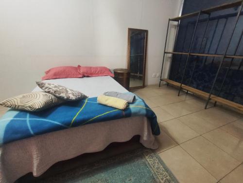 a bedroom with a bed with two pillows on it at Nova Jerusalém in Cianorte