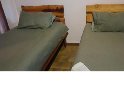 two beds sitting next to each other in a room at Inkonka Game farm in Uitsig
