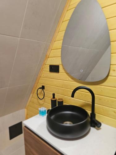 a bathroom with a black sink and a mirror at Mestia POV Luxury Cabins in Mestia