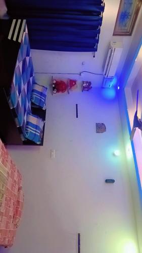 a room with several beds and a ceiling with blue lights at kanak homestay in Ayodhya