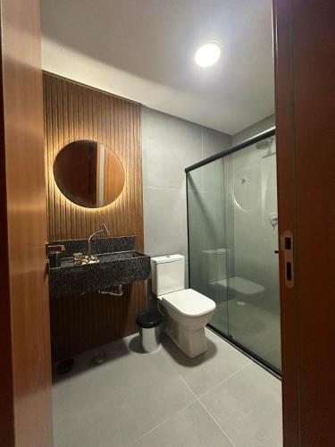 a bathroom with a toilet and a sink and a shower at Apartamento Luxo em Japaratinga in Japaratinga