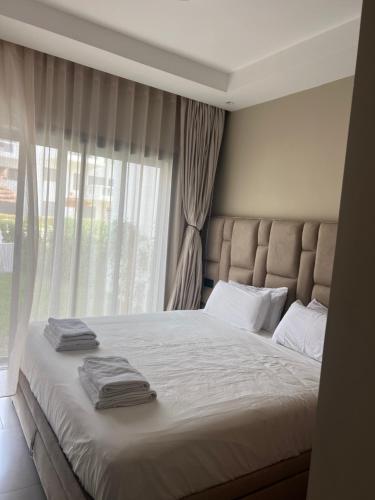 a bedroom with a large bed with towels on it at Cabo Luxury stay in Cabo Negro