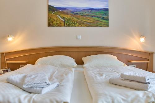 a bedroom with two beds with towels on them at Gästehaus Binz-Meyer Fewo Paulsberg in Lieser
