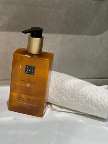 a bottle of soap sitting next to a towel at Cabo Luxury stay in Cabo Negro