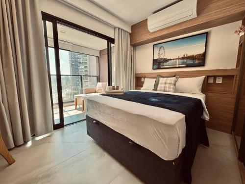a bedroom with a large bed and a large window at 505A - Rentaqui Studio Moema Stylo São Paulo in Sao Paulo