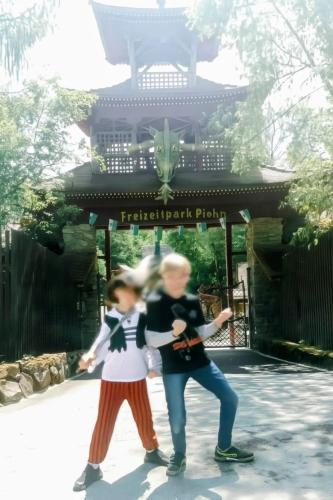 a couple of people dancing in front of a pagoda at Nähe Plohn Park - FEWO mit Spielzimmer und Balkon, DZ in Auerbach