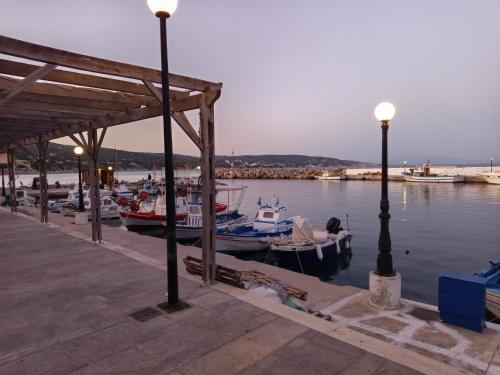 a group of boats are docked at a dock at Chez moi in Chios