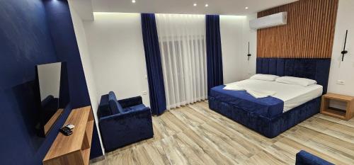 a bedroom with a bed and a tv in it at Vila Sela in Shkodër
