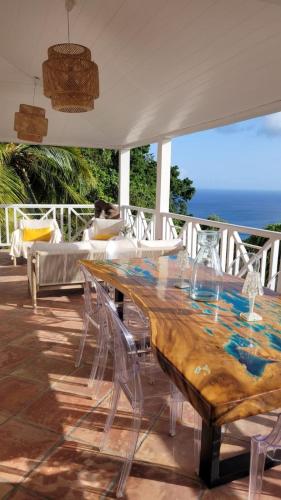 a wooden table and chairs on a patio at Villa Clémentine in Le Diamant