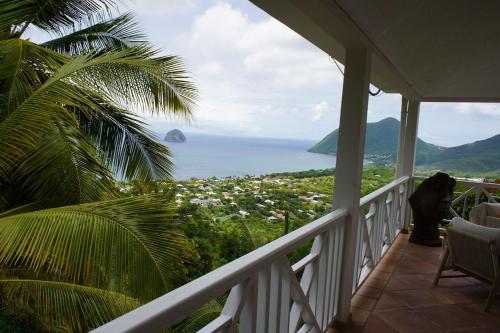 a porch with a view of the ocean at Villa Clémentine in Le Diamant