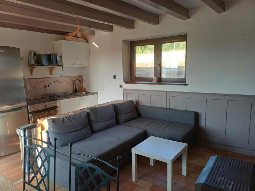 a living room with a couch and a table at Exceptional cottage in Tournus