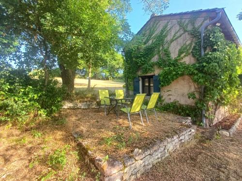 a table and chairs in front of a house at Exceptional cottage in Tournus