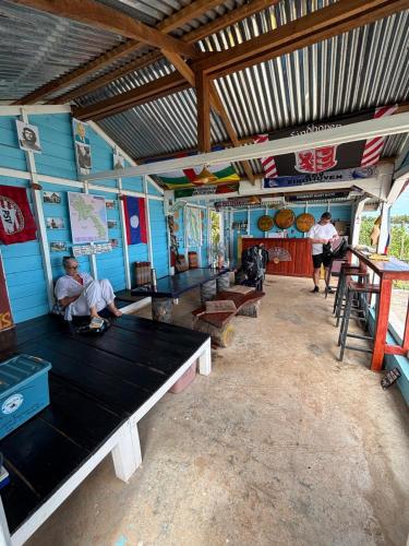 a room with blue walls and a large black table at Don Som Riverside Guesthouse in Don Som