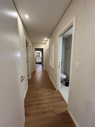 a hallway of a house with wooden floors and white walls at The Place to Stay ! in Póvoa de Santa Iria