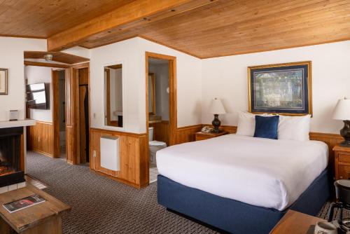 a bedroom with a large bed and a fireplace at Carmel Fireplace Inn in Carmel